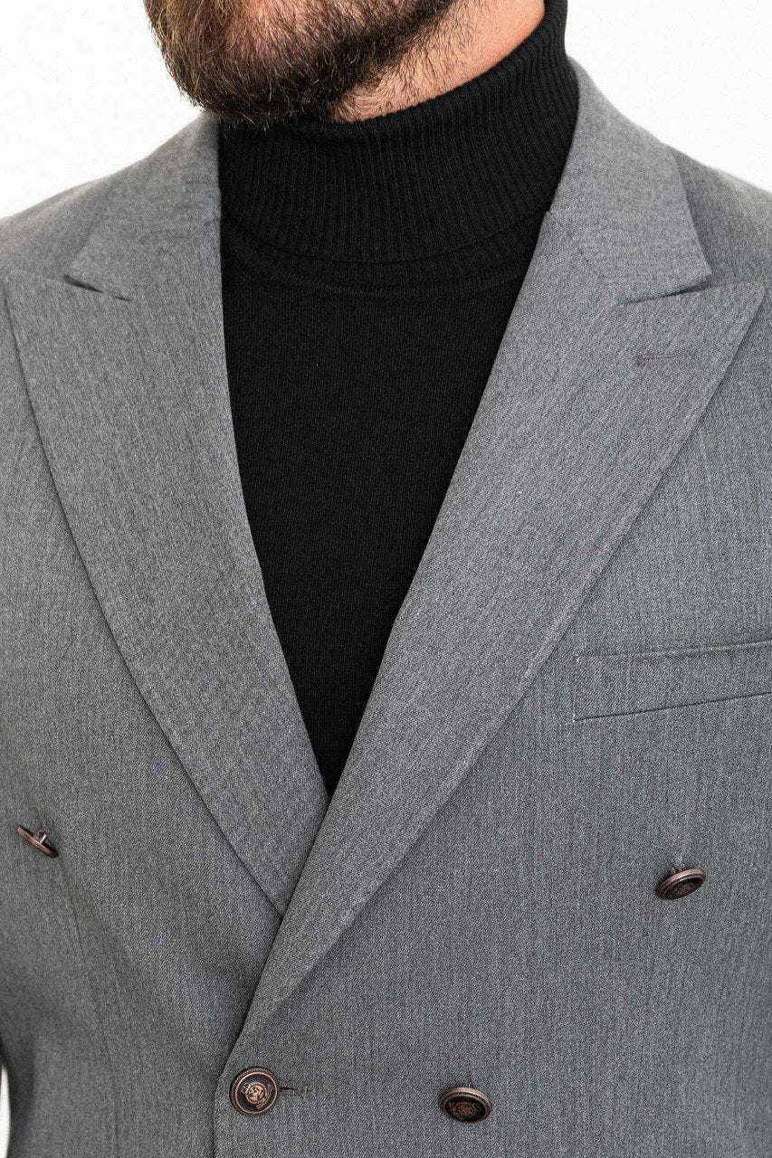 Man wearing a grey double-breasted blazer paired with a black turtleneck, ideal for smart-casual and formal occasions.