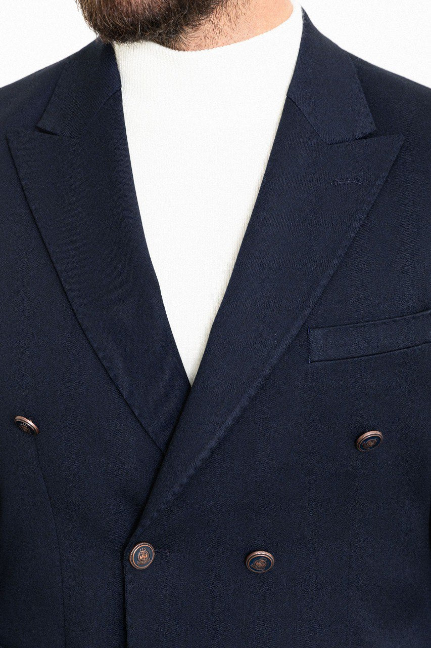 Man wearing a navy double-breasted blazer with a white turtleneck, perfect for formal and smart-casual occasions.