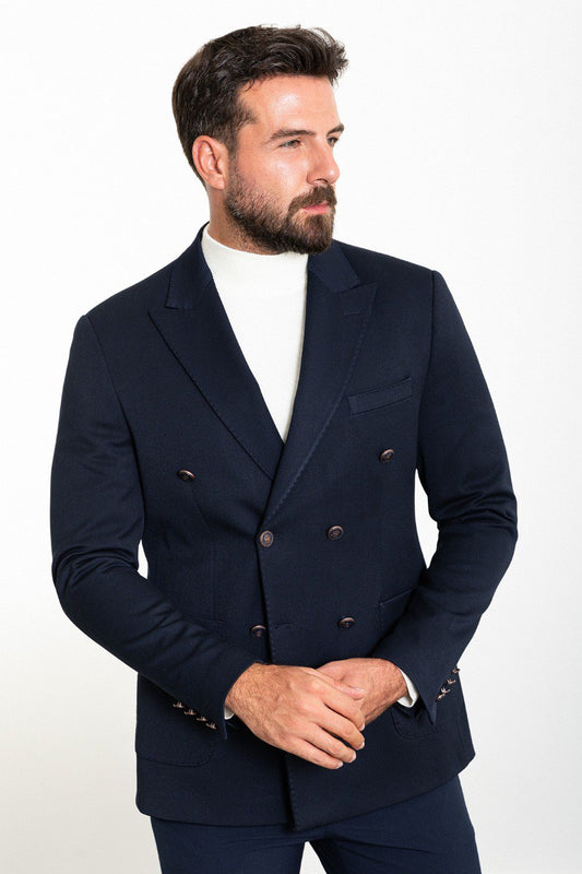Man wearing a navy double-breasted blazer with a white turtleneck, perfect for formal and smart-casual occasions.