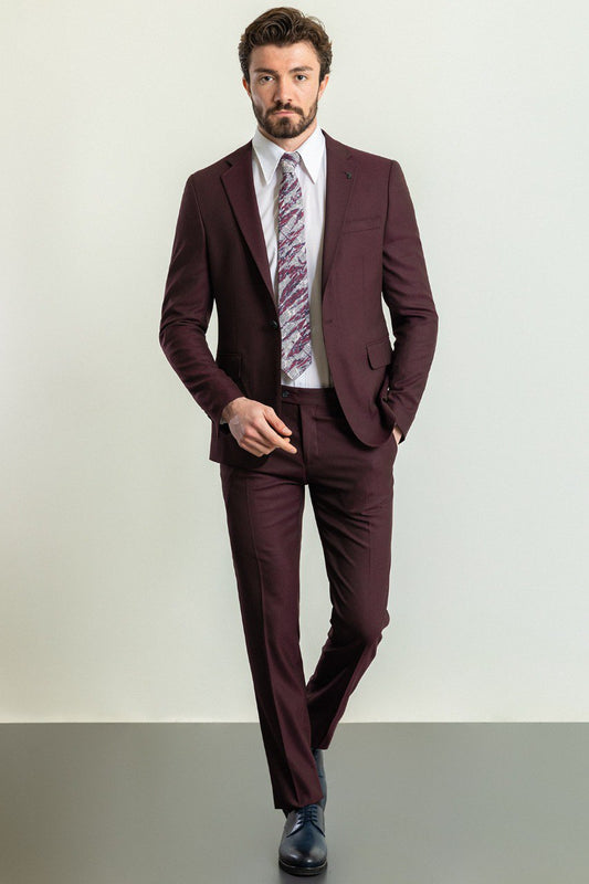 Man wearing a Bordeaux Regal Suit with a sharp pointed collar, flap pockets, and a slim fit, perfect for weddings and business events.