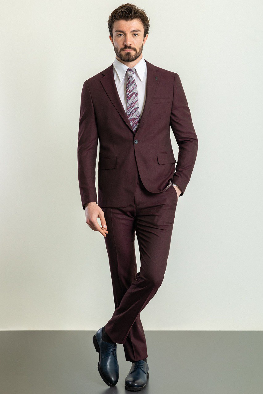 Man wearing a Bordeaux Regal Suit with a sharp pointed collar, flap pockets, and a slim fit, perfect for weddings and business events.