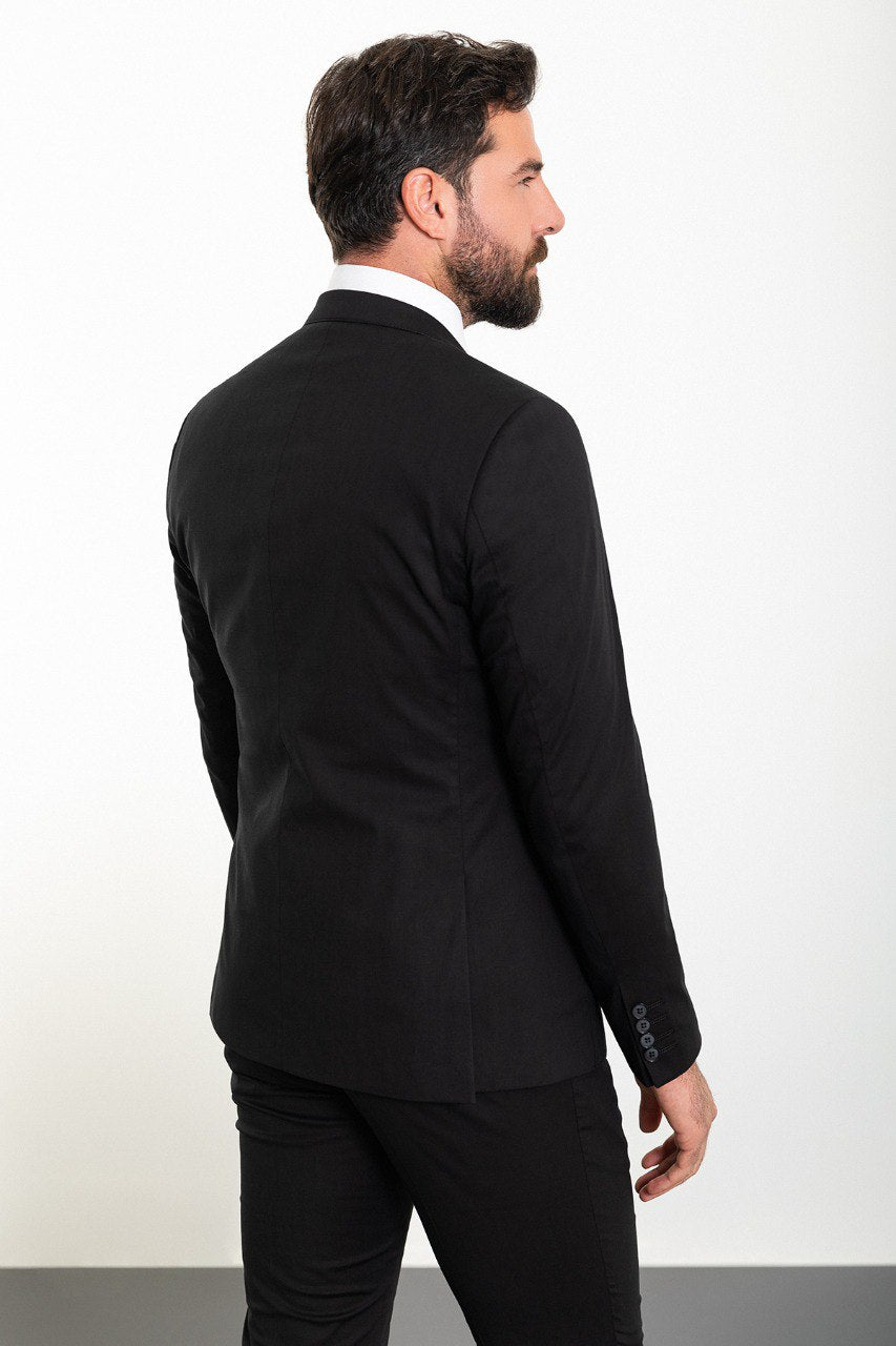 Man in a black double-breasted tuxedo with shawl lapel.