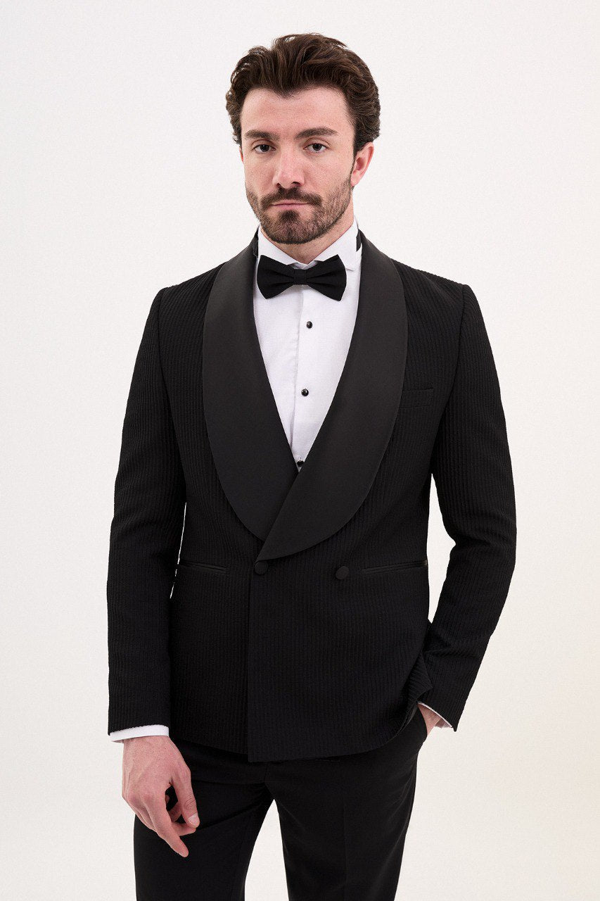 Man in a black double-breasted tuxedo with shawl lapel.