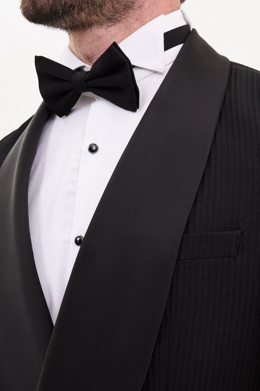 Man in a black double-breasted tuxedo with shawl lapel.