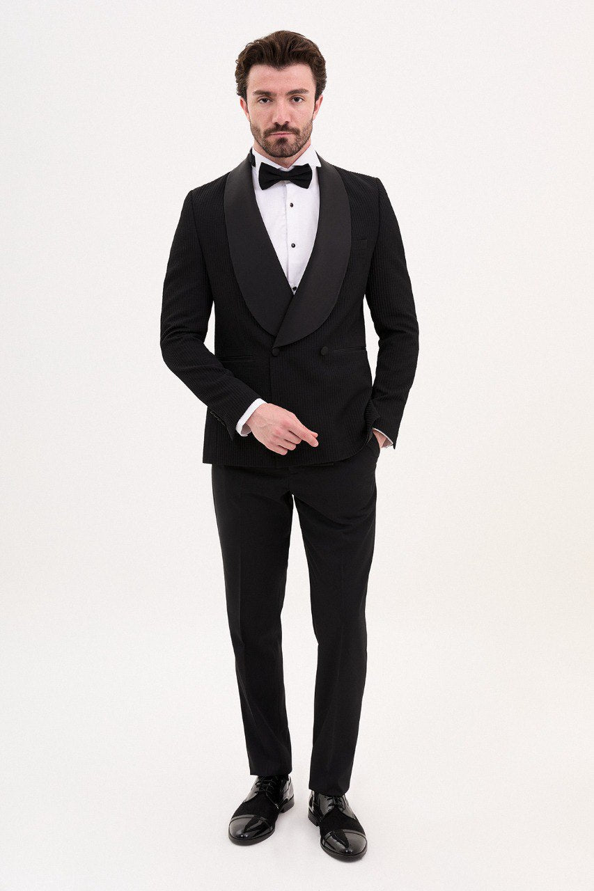 Man in a black double-breasted tuxedo with shawl lapel.