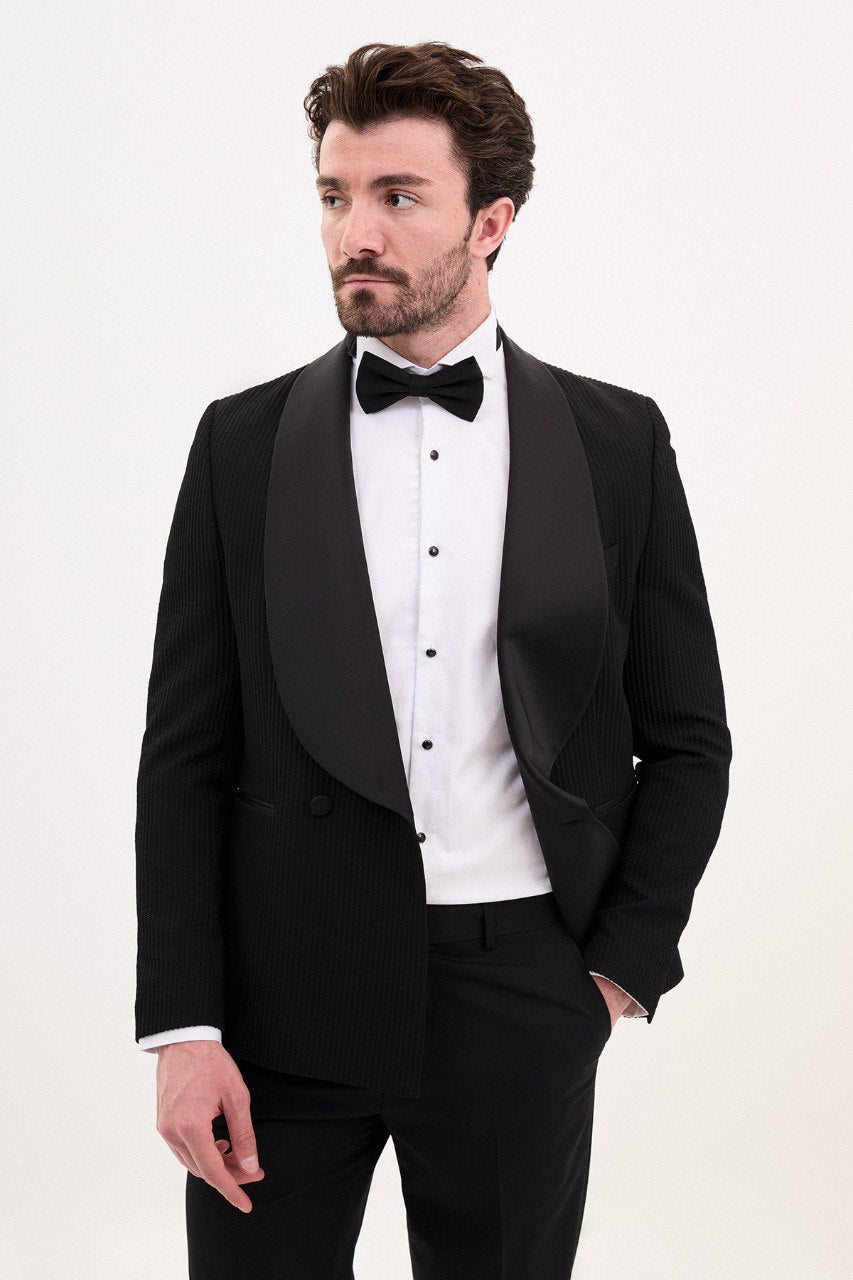 Man in a black double-breasted tuxedo with shawl lapel.