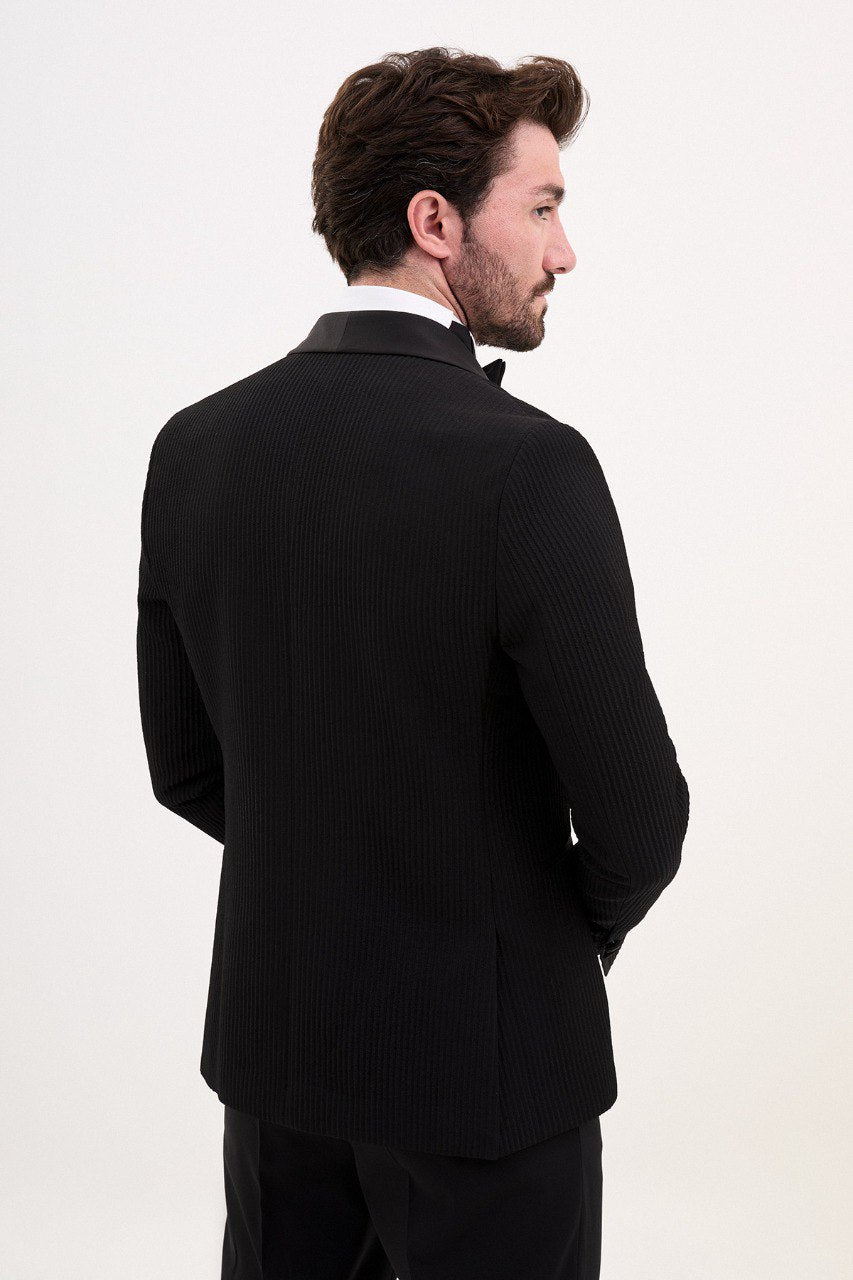 Man in a black double-breasted tuxedo with shawl lapel.