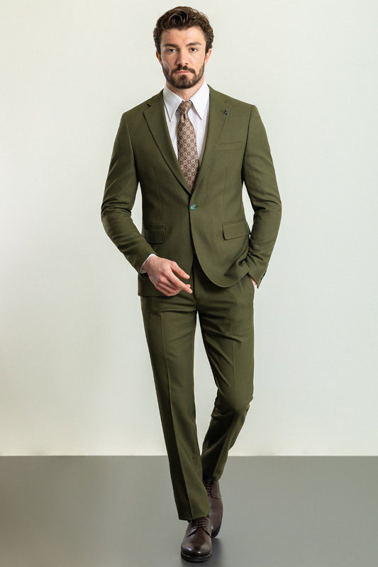 Man wearing an Olive Grove Suit with a sharp pointed collar, flap pockets, and a slim fit, perfect for weddings and business engagements.