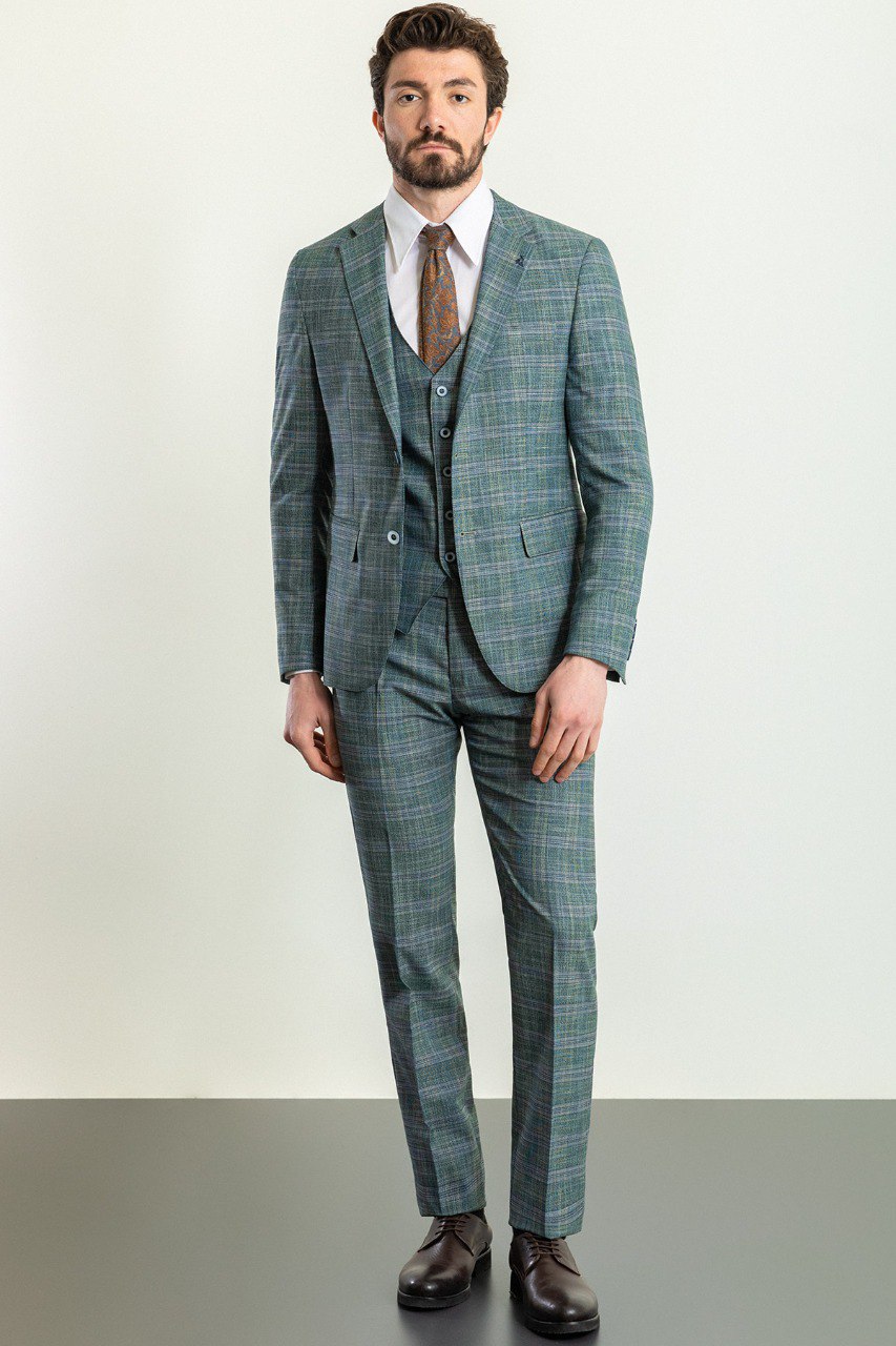 Man wearing an Emerald Plaid 3-Piece Suit with a sharp pointed collar, flap pockets, and a slim fit, perfect for weddings and business engagements.