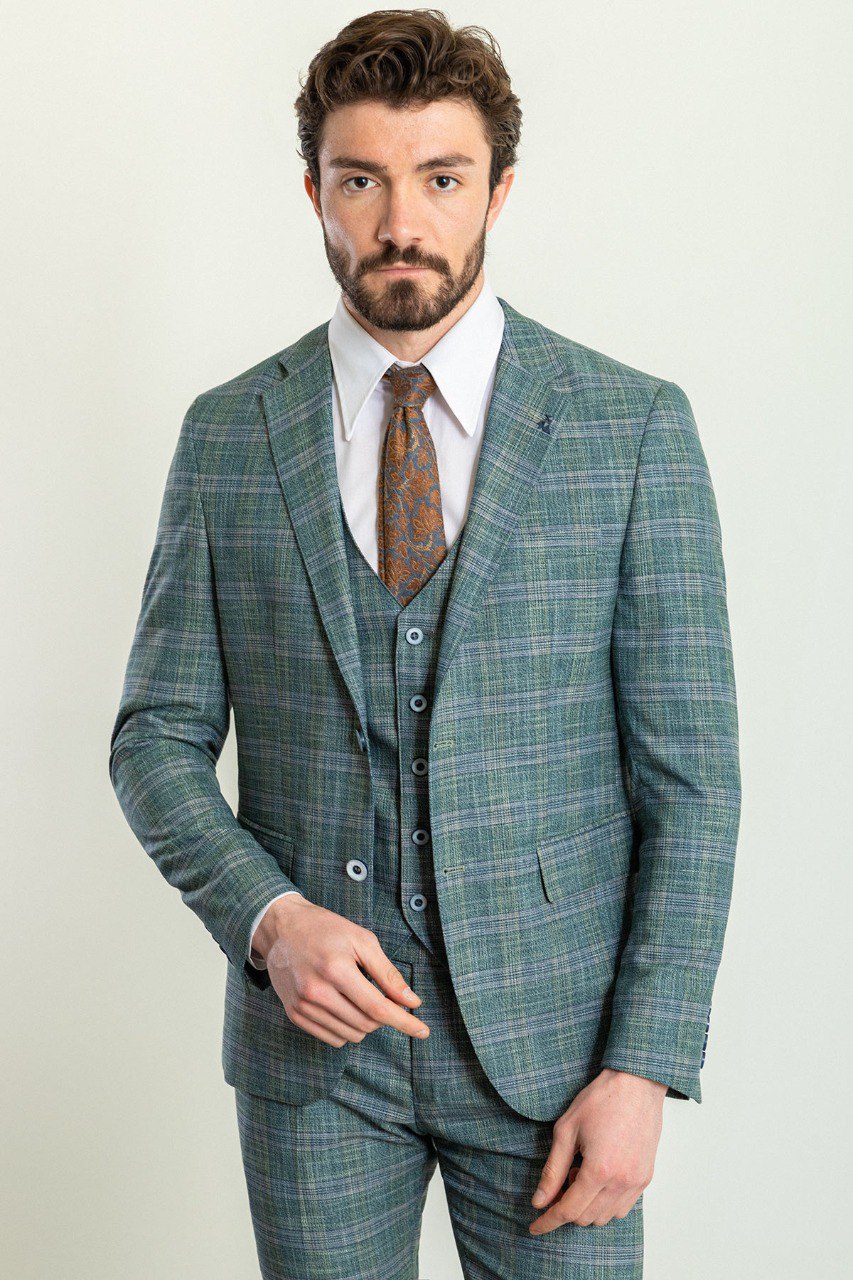 Man wearing an Emerald Plaid 3-Piece Suit with a sharp pointed collar, flap pockets, and a slim fit, perfect for weddings and business engagements.