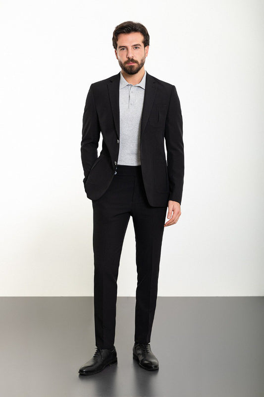 Man wearing the Onyx Casual Comfort Suit, a black slim fit suit with extra pockets, perfect for casual yet sophisticated occasions.