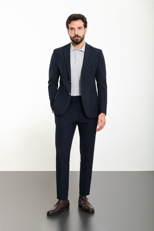 Man wearing the Midnight Casual Elegance Suit, a navy blue slim fit suit with extra pockets, ideal for casual yet refined occasions.