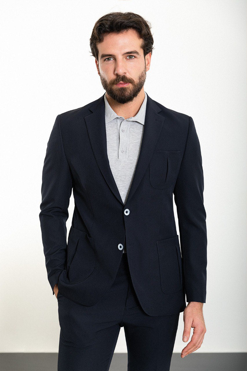 Man wearing the Midnight Casual Elegance Suit, a navy blue slim fit suit with extra pockets, ideal for casual yet refined occasions.