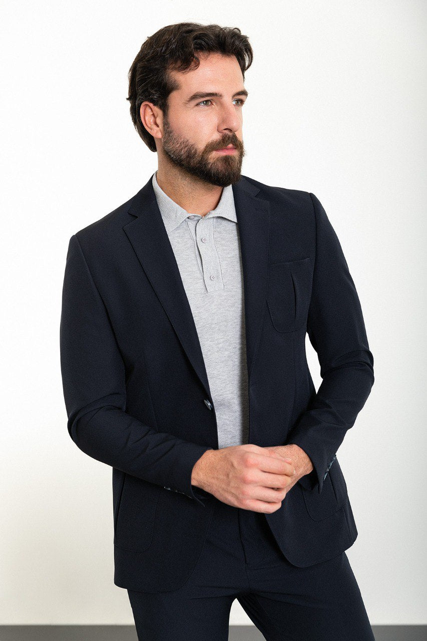 Man wearing the Midnight Casual Elegance Suit, a navy blue slim fit suit with extra pockets, ideal for casual yet refined occasions.