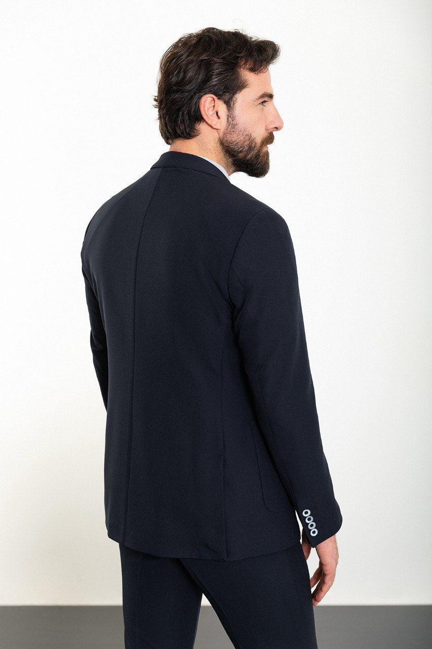 Man wearing the Midnight Casual Elegance Suit, a navy blue slim fit suit with extra pockets, ideal for casual yet refined occasions.