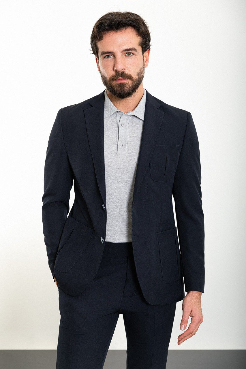 Man wearing the Midnight Casual Elegance Suit, a navy blue slim fit suit with extra pockets, ideal for casual yet refined occasions.