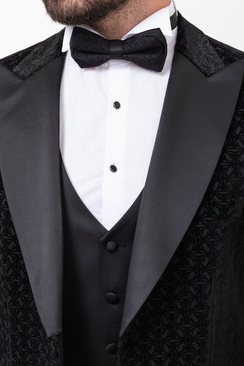 Man in a black double-breasted tuxedo with a bow tie.