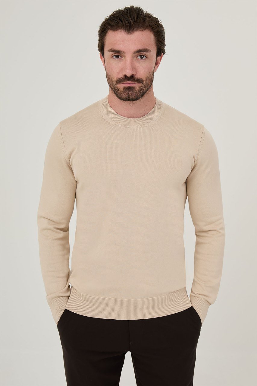 Front view of a man wearing a beige crew neck sweater