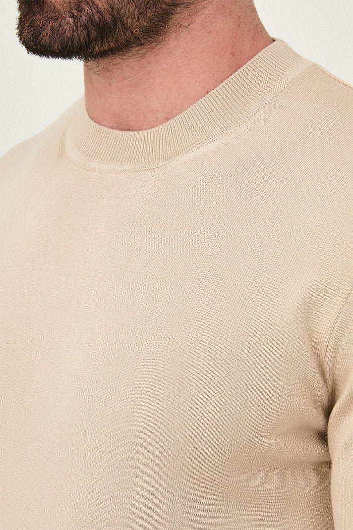 Close-up of the beige sweater's fine knit and crew neckline