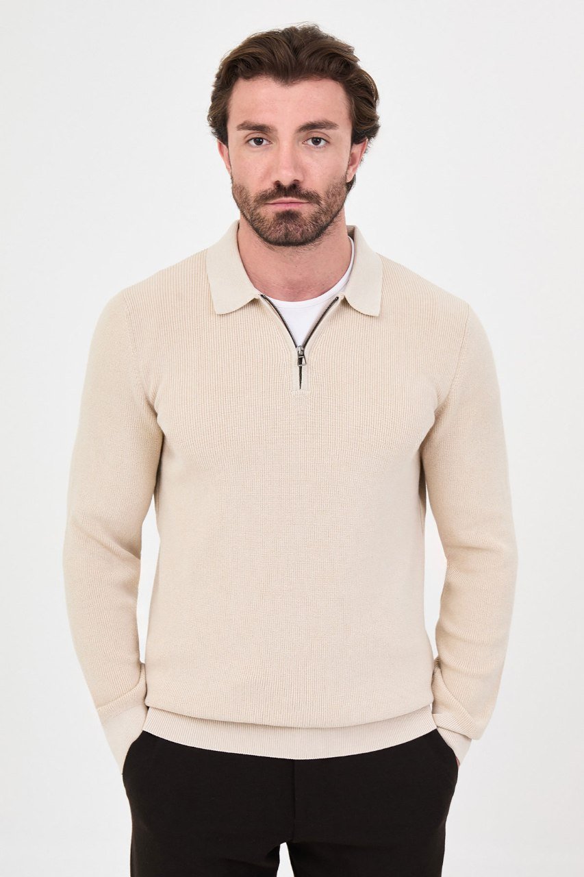 Front view of a man wearing a beige ribbed quarter-zip polo sweater