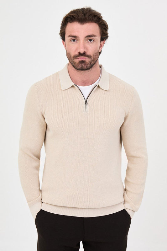 Front view of a man wearing a beige ribbed quarter-zip polo sweater