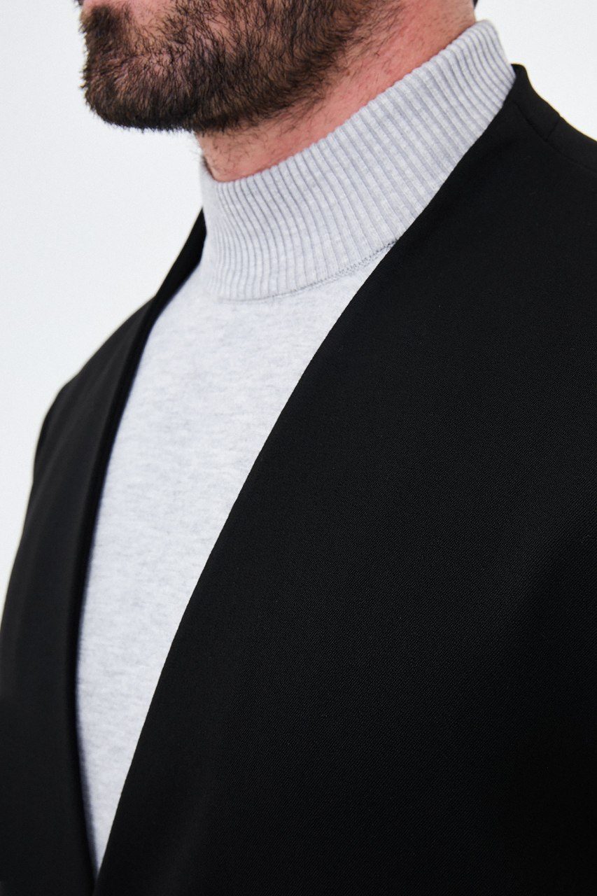Men's black collarless one-button two-piece suit neckline fabric detail