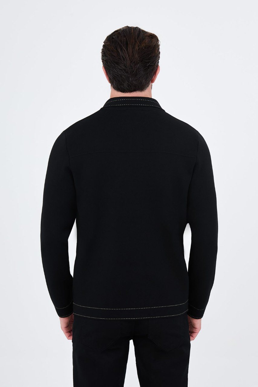 Man wearing a black button-front cardigan with contrast trim, back view
