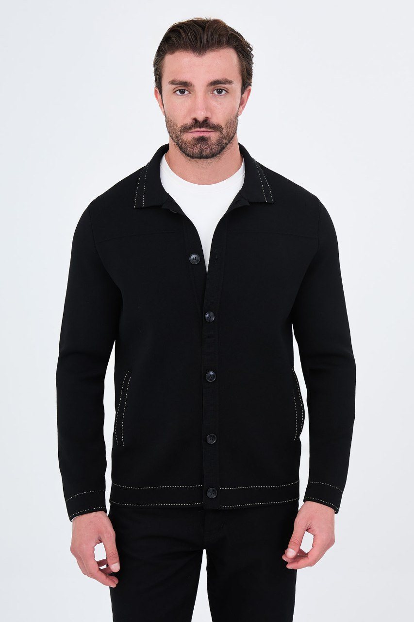 Man wearing a black button-front cardigan with contrast trim, front view