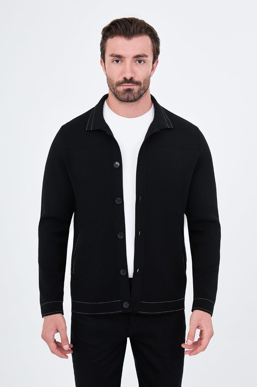 Man wearing a black button-front cardigan with contrast trim, open front view