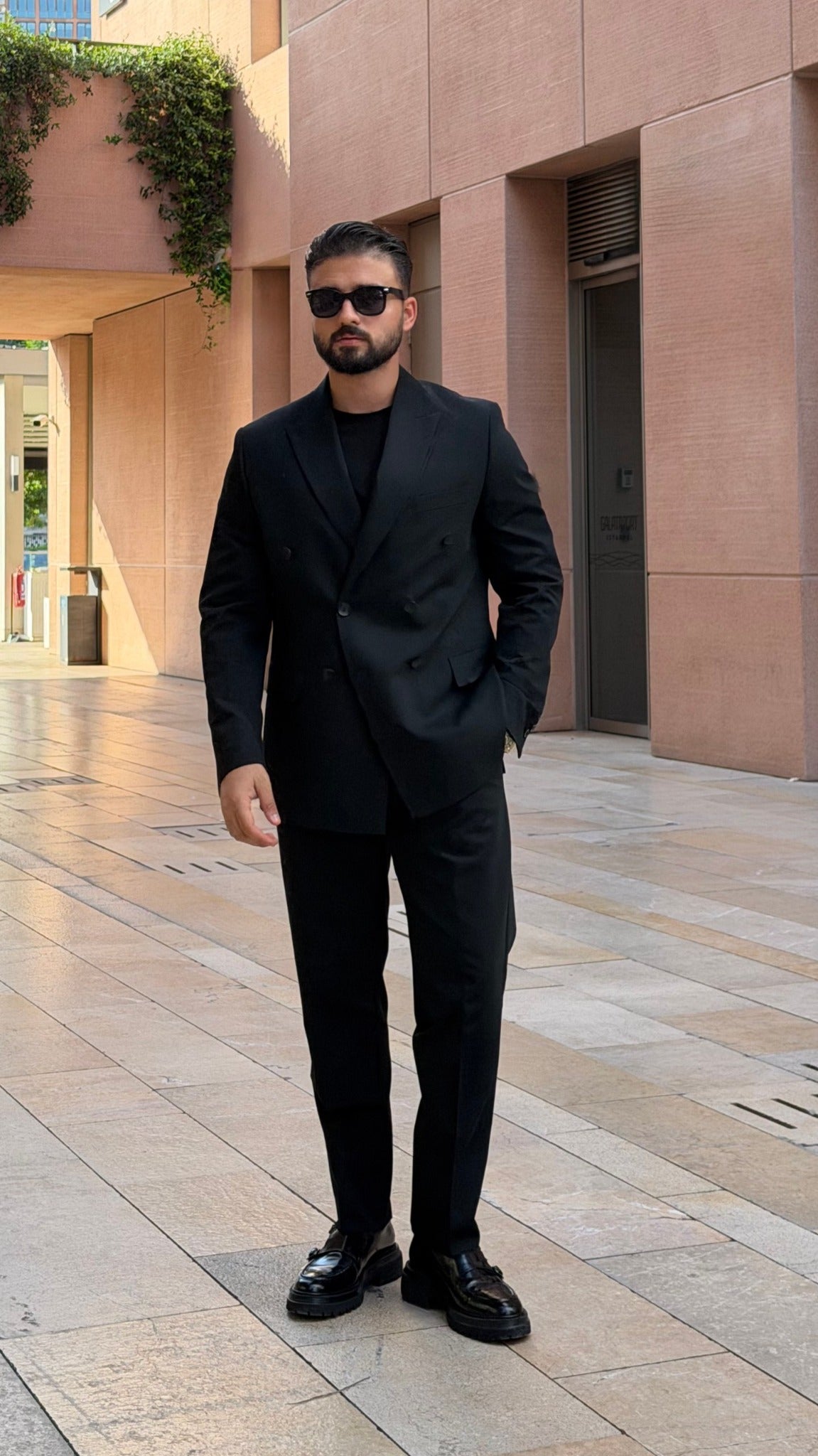 Men's black double-breasted suit full-length look with loafers