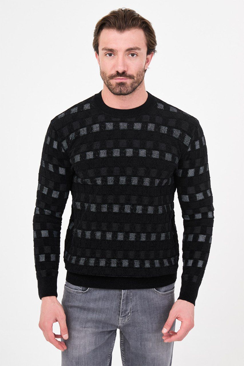 Front view of a man wearing a black geometric knit crew neck sweater