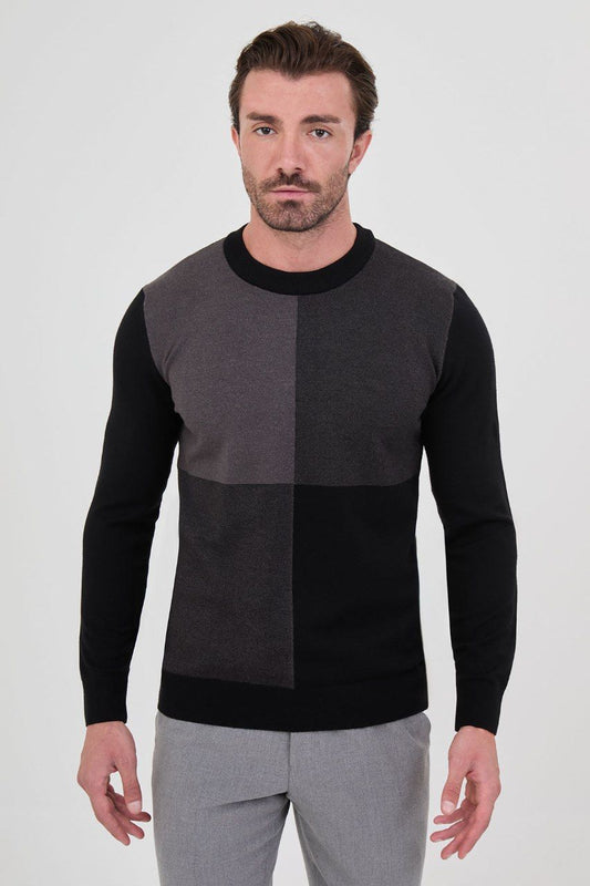 Front view of a man wearing a black and grey colour-block crew neck sweater