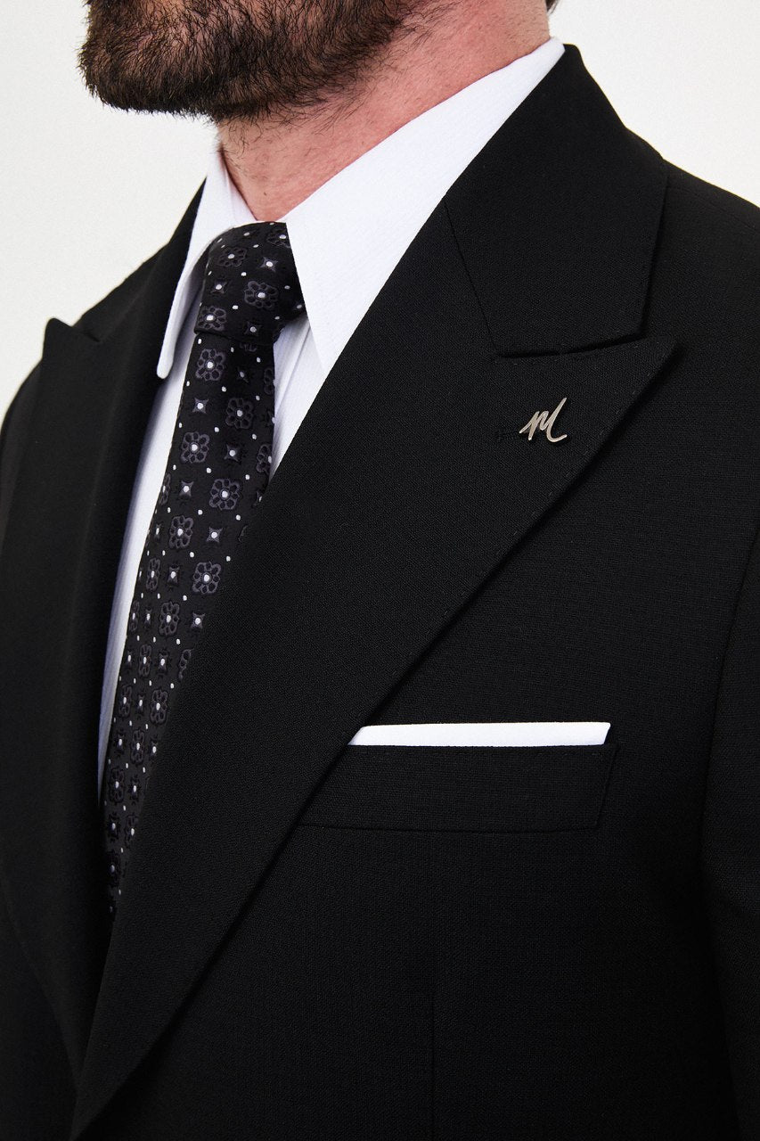 Men's black slim-fit two-piece suit peak lapel close-up