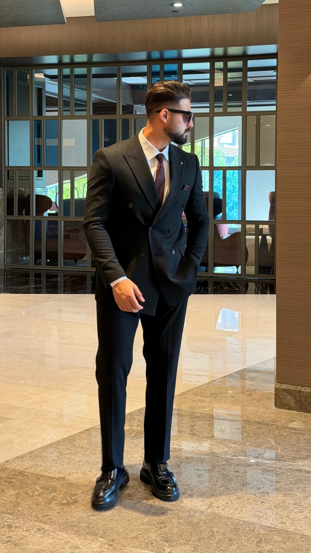 Men's black pinstripe double-breasted suit side view