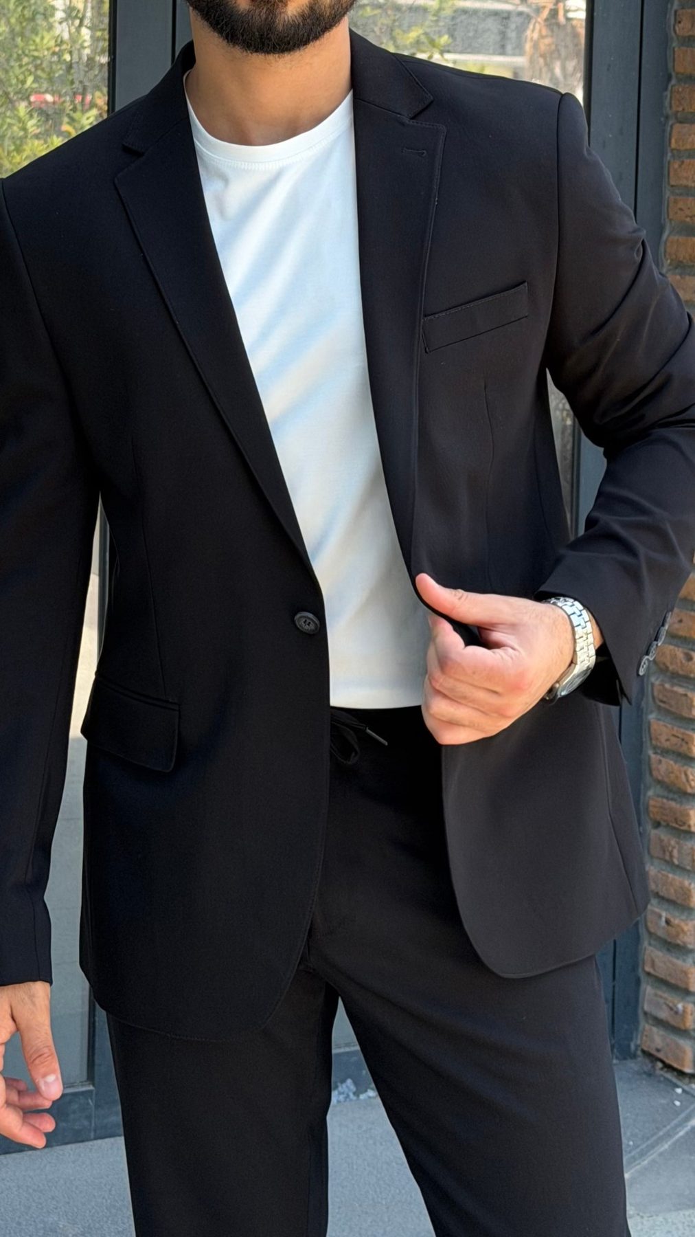 Men's black single-breasted suit notch lapel and fabric detail