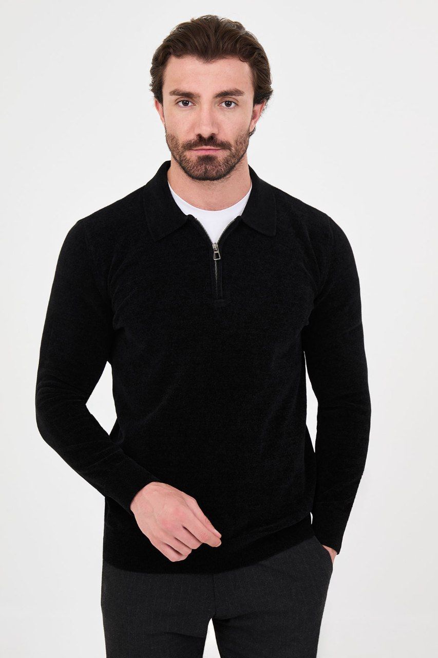 Front view of a man wearing a black textured quarter-zip polo sweater