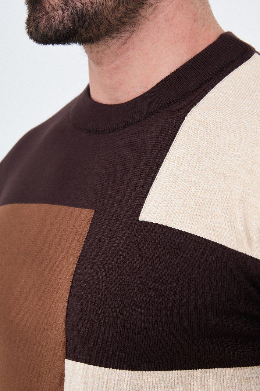 Close-up of the brown sweater's crew neckline and asymmetric colour-block knit