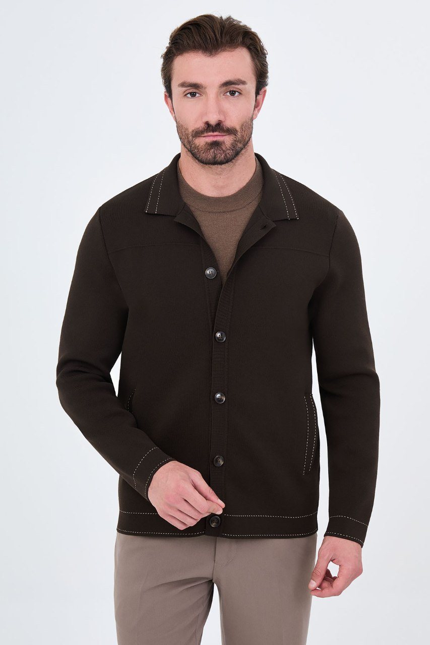 Man wearing a brown button-front cardigan with contrast trim, angled view