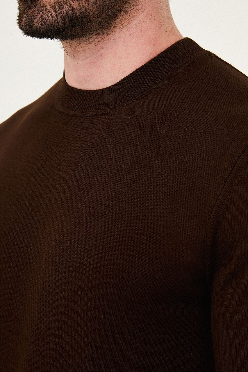 Close-up of the brown sweater's crew neckline and fine knit