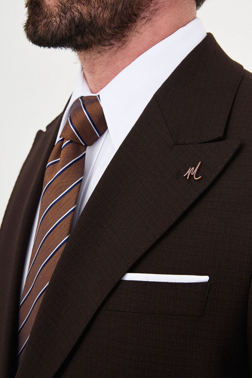 Men's dark brown slim-fit two-piece suit peak lapel close-up
