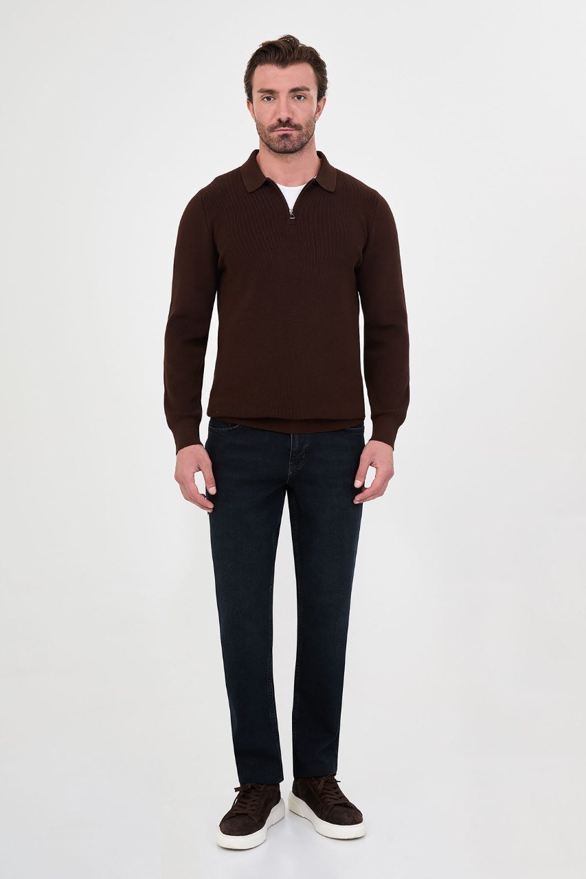 Man wearing a brown ribbed quarter-zip polo sweater with dark jeans