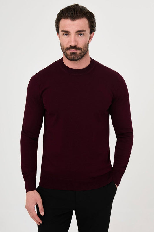 Front view of a man wearing a burgundy crew neck sweater with long sleeves