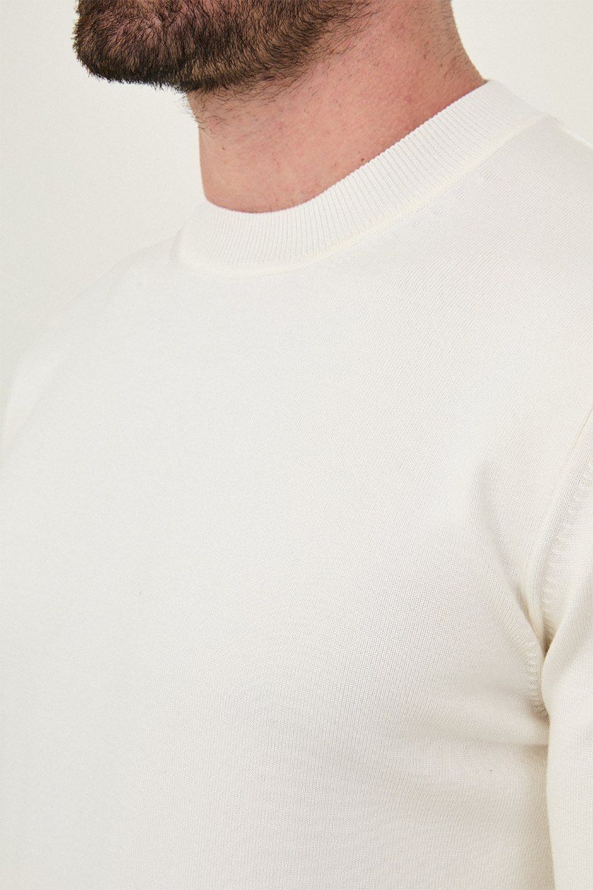 Close-up of the ecru sweater's fine knit and crew neckline