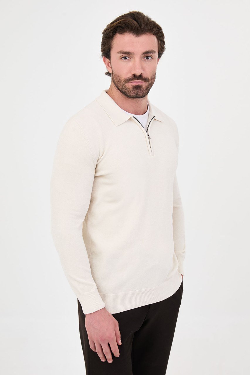 Angled view of a man wearing a ecru textured quarter-zip polo sweater