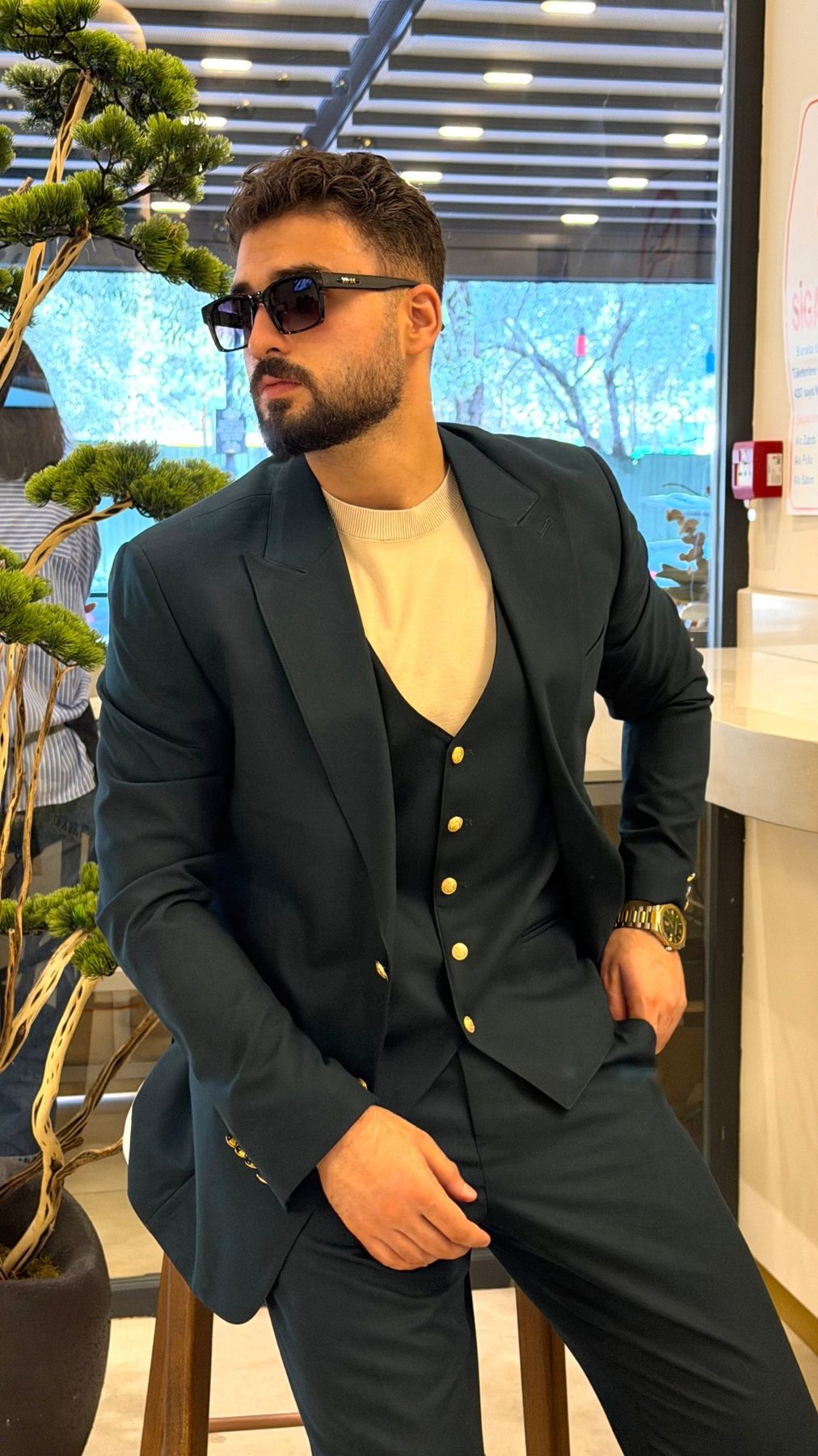 Front view of men's emerald green three-piece suit with gold-tone buttons