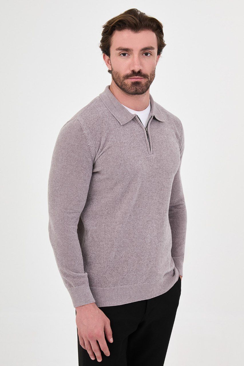 Angled view of a man wearing a grey textured quarter-zip polo sweater