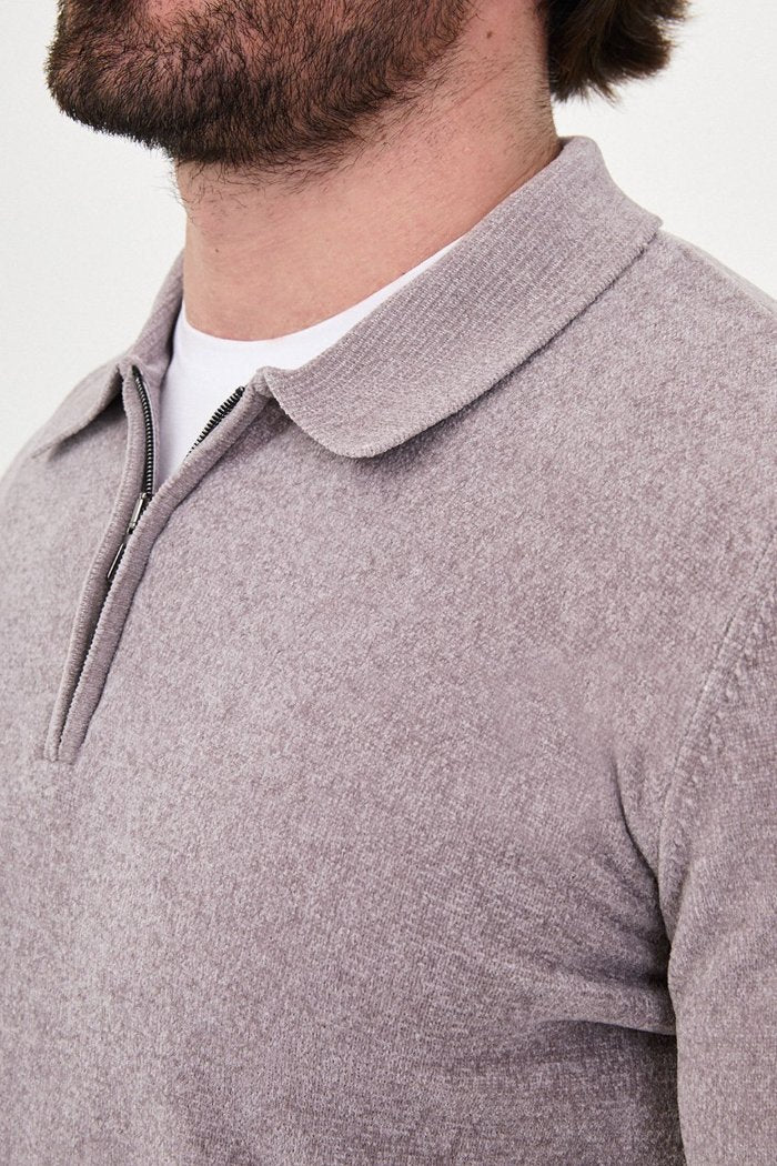Close-up of the grey sweater's textured knit, polo collar and quarter-zip fastening