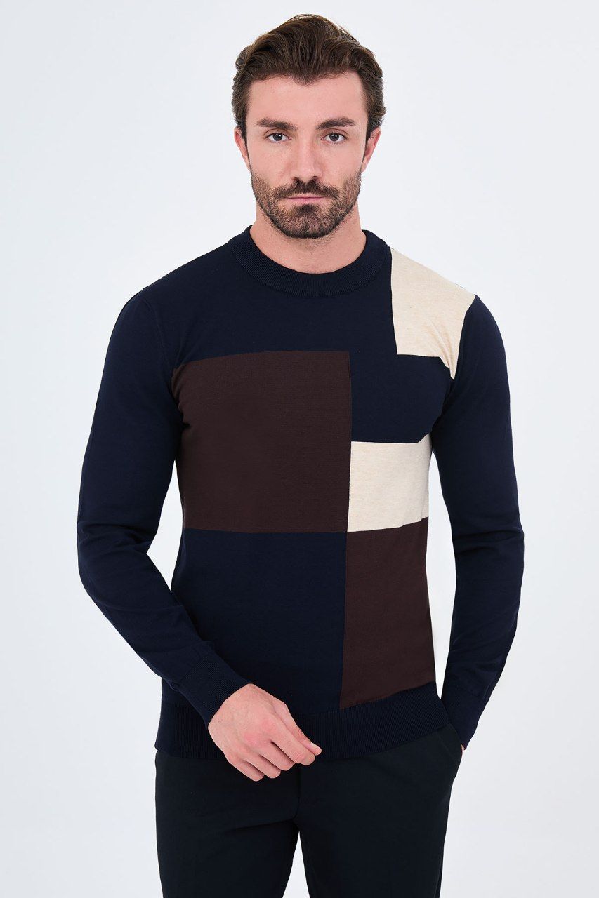 Front view of a man wearing a navy blue asymmetric colour-block crew neck sweater