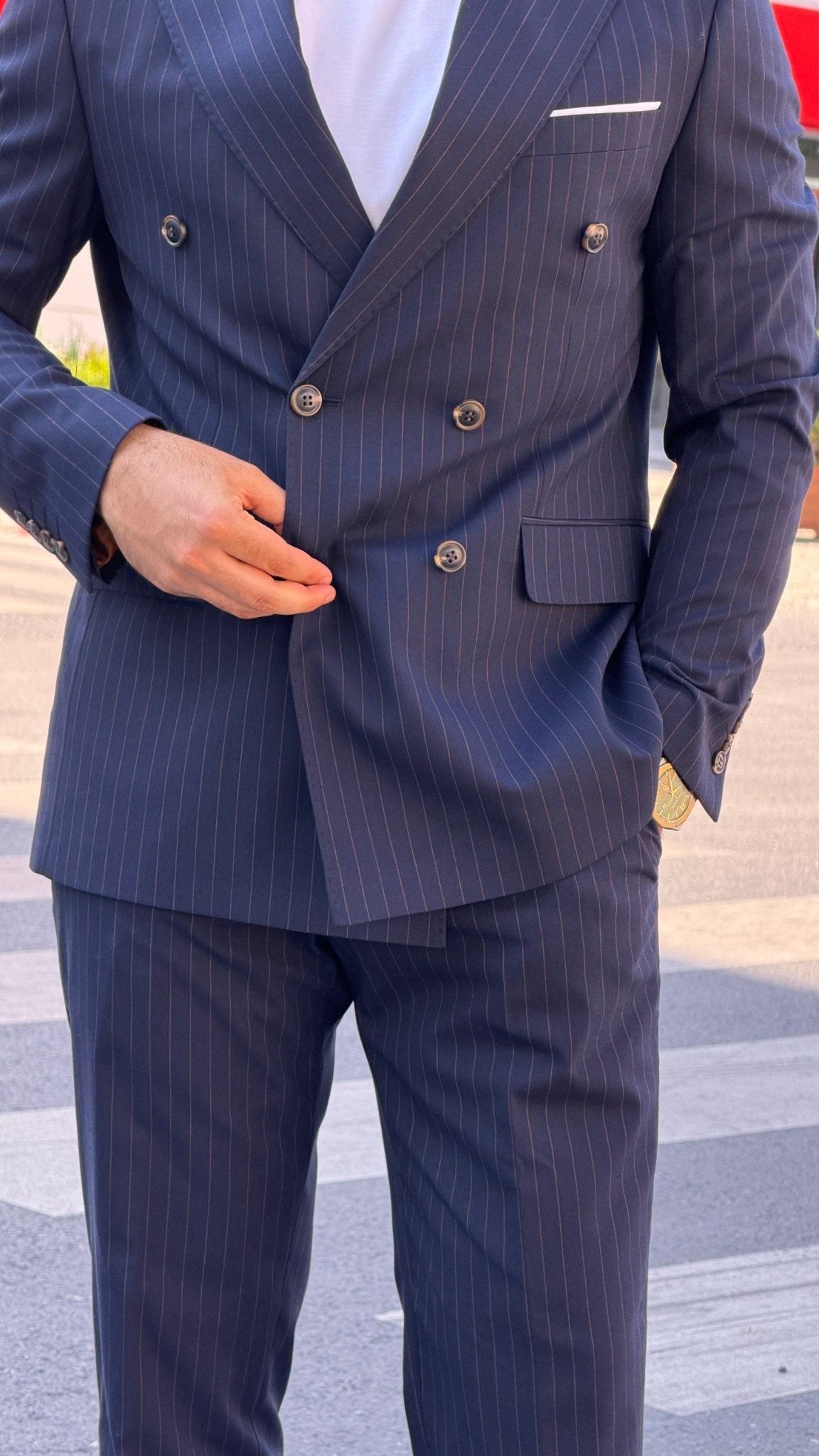 Navy blue pinstripe double-breasted suit jacket and matching trouser detail