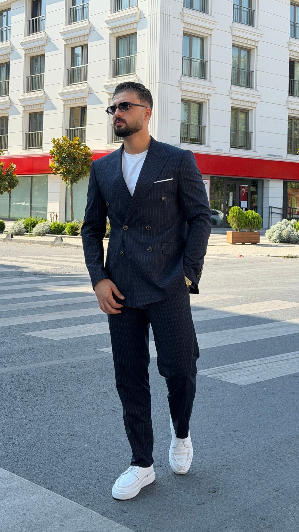 Men's navy blue pinstripe double-breasted two-piece suit, full-length view